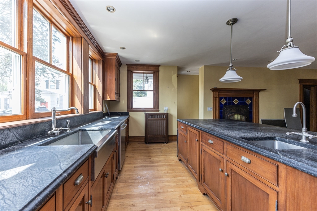 29 Gorham Street Chelmsford, MA 01824 - Photo 14 of 42 a large kitchen with kitchen island granite countertop a large island in the center
