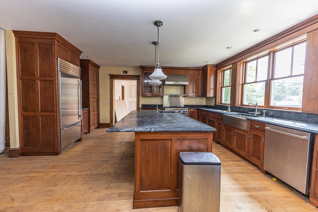 29 Gorham Street Chelmsford, MA 01824 - Photo 16 of 42 a kitchen with stainless steel appliances granite countertop a stove and a refrigerator