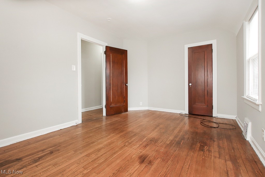 3973 Navahoe Road Cleveland, OH 44121 - Photo 11 of 14 Spare room with hardwood / wood-style floors, visible vents, and baseboards