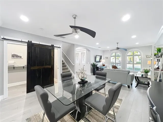 a kitchen with stainless steel appliances granite countertop a sink refrigerator and cabinets