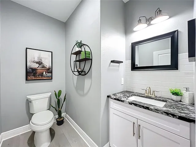 a living room with furniture potted plant and wooden floor