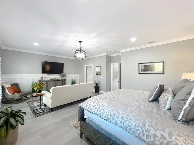 a spacious bathroom with a double vanity sink a toilet a mirror and shower