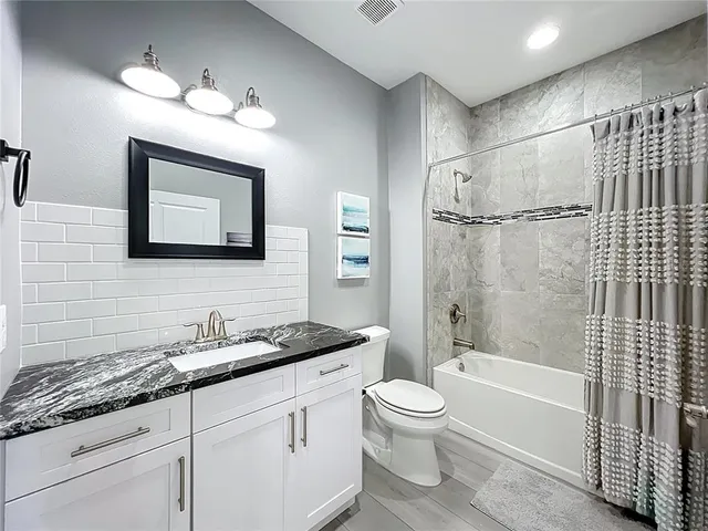 a view of a livingroom with furniture and a floor to ceiling window