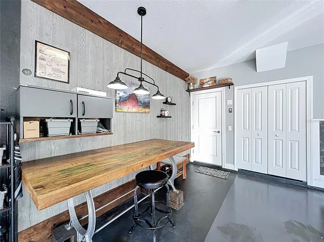an aerial view of a house with a garden and lake view