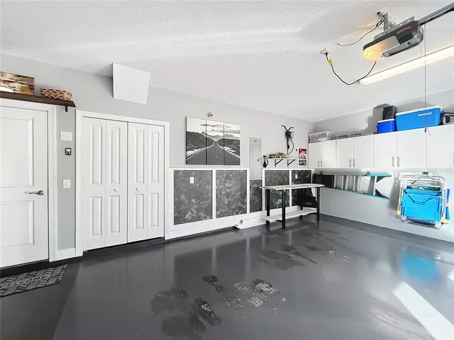 an aerial view of residential houses with outdoor space and lake view