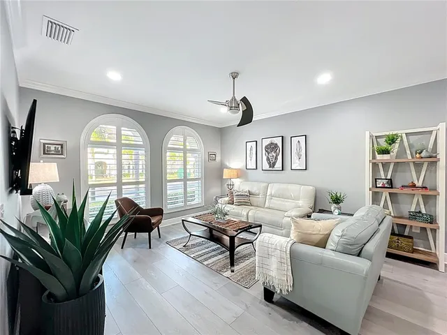 a living room with furniture and a wooden floor