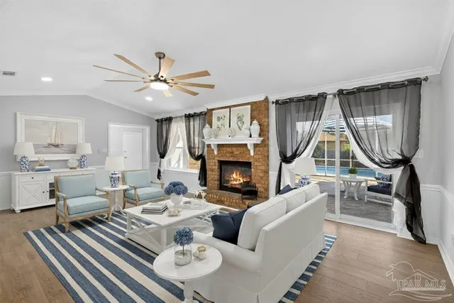 a living room with furniture a fireplace and a chandelier