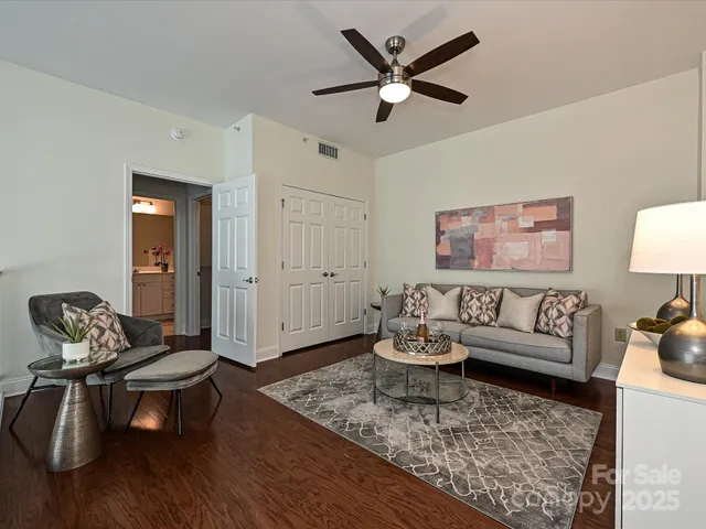 a living room with furniture and a wooden floor