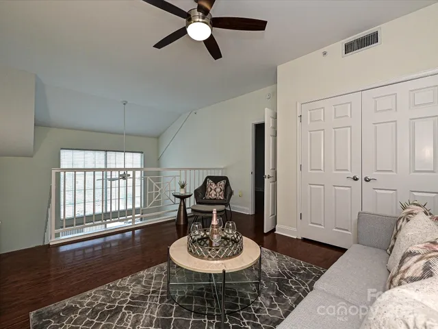 a view of a room with a mirror and fan