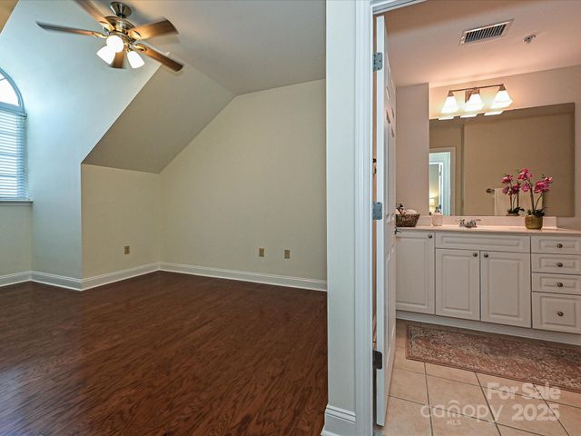 a view of a room with a mirror and fan
