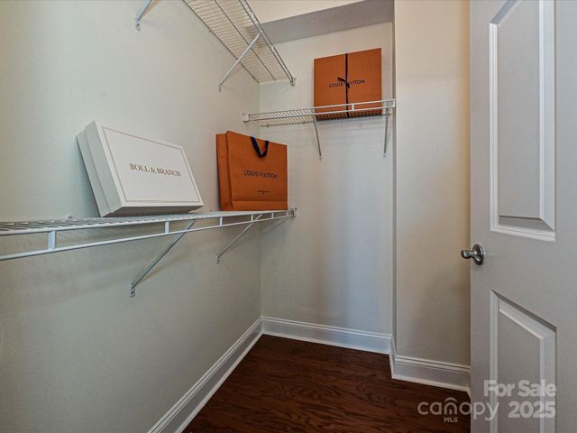 a view of walk in closet with clothes