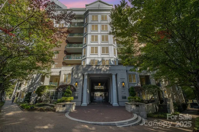 a view of a city with tall buildings and a big yard