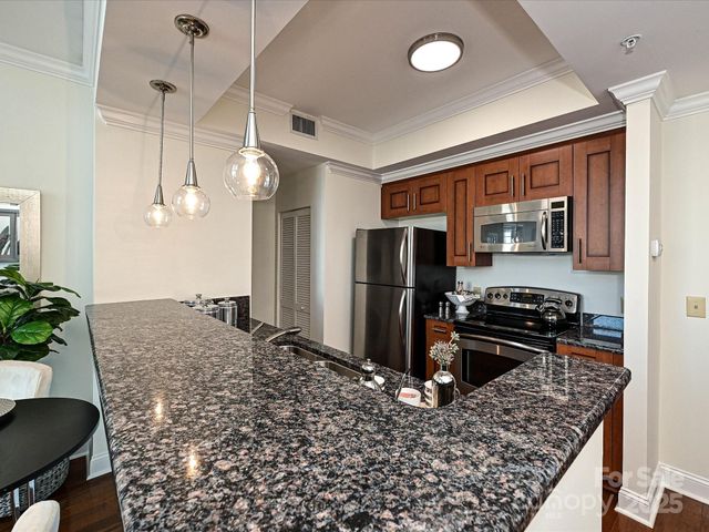 a kitchen with a refrigerator and a stove top oven