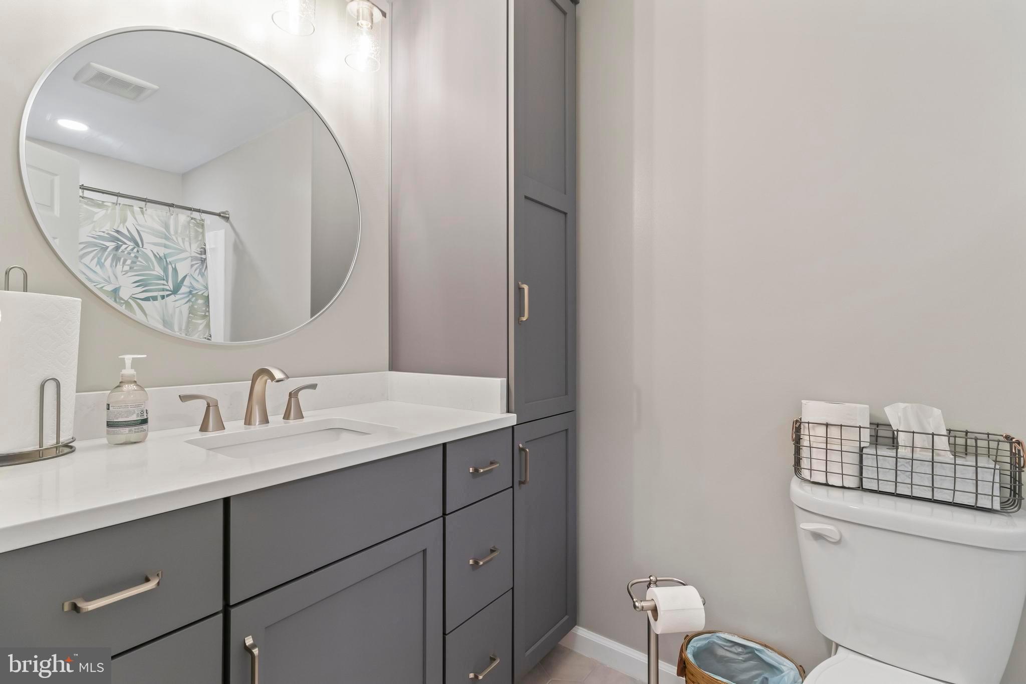 44350 Clarkes Landing Road Hollywood, MD 20636 - Photo 16 of 39 a bathroom with a toilet a sink and mirror