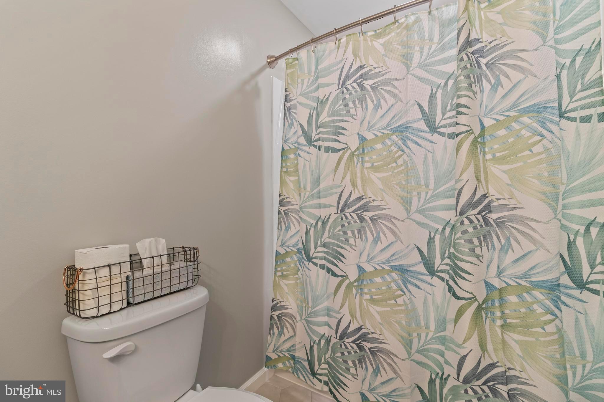 44350 Clarkes Landing Road Hollywood, MD 20636 - Photo 17 of 39 a white toilet sitting next to a shower curtain