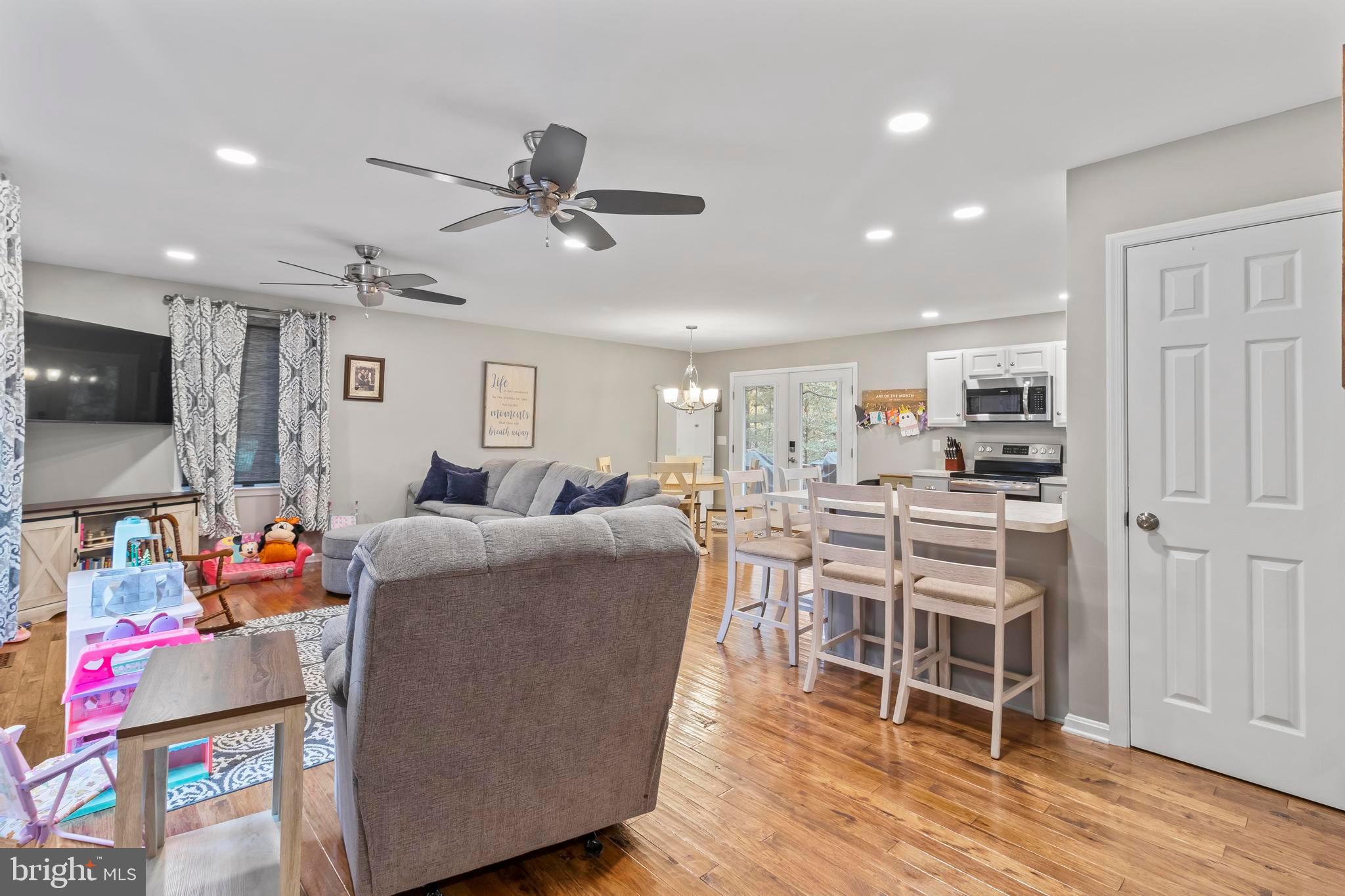 44350 Clarkes Landing Road Hollywood, MD 20636 - Photo 19 of 39 a living room with furniture a wooden floor and a window