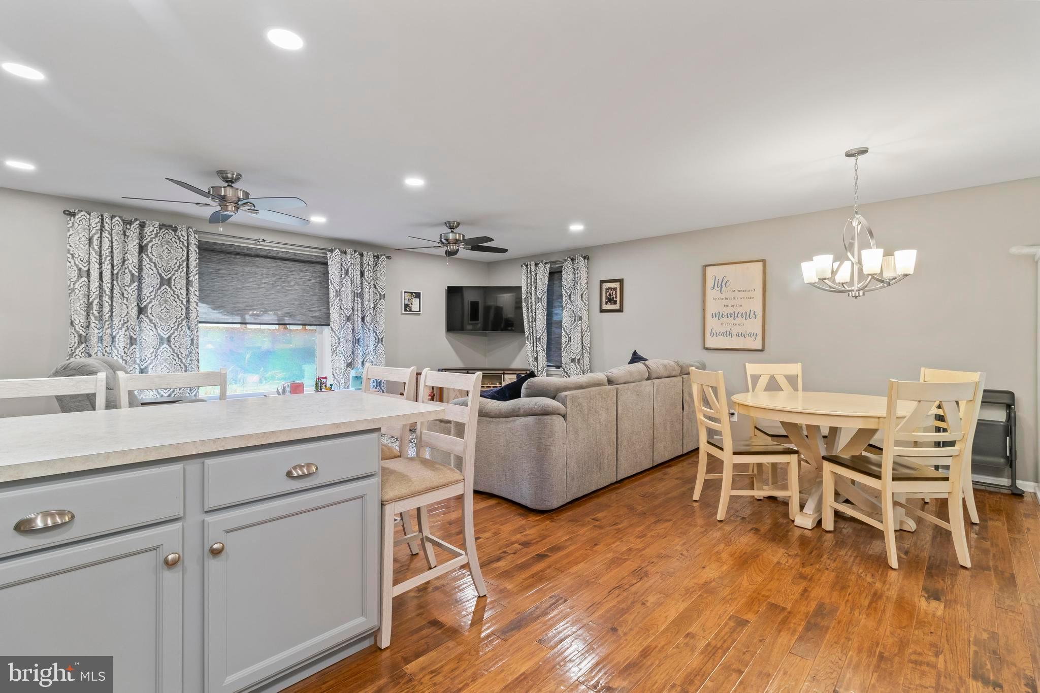 44350 Clarkes Landing Road Hollywood, MD 20636 - Photo 20 of 39 a living room with furniture kitchen view and a wooden floor