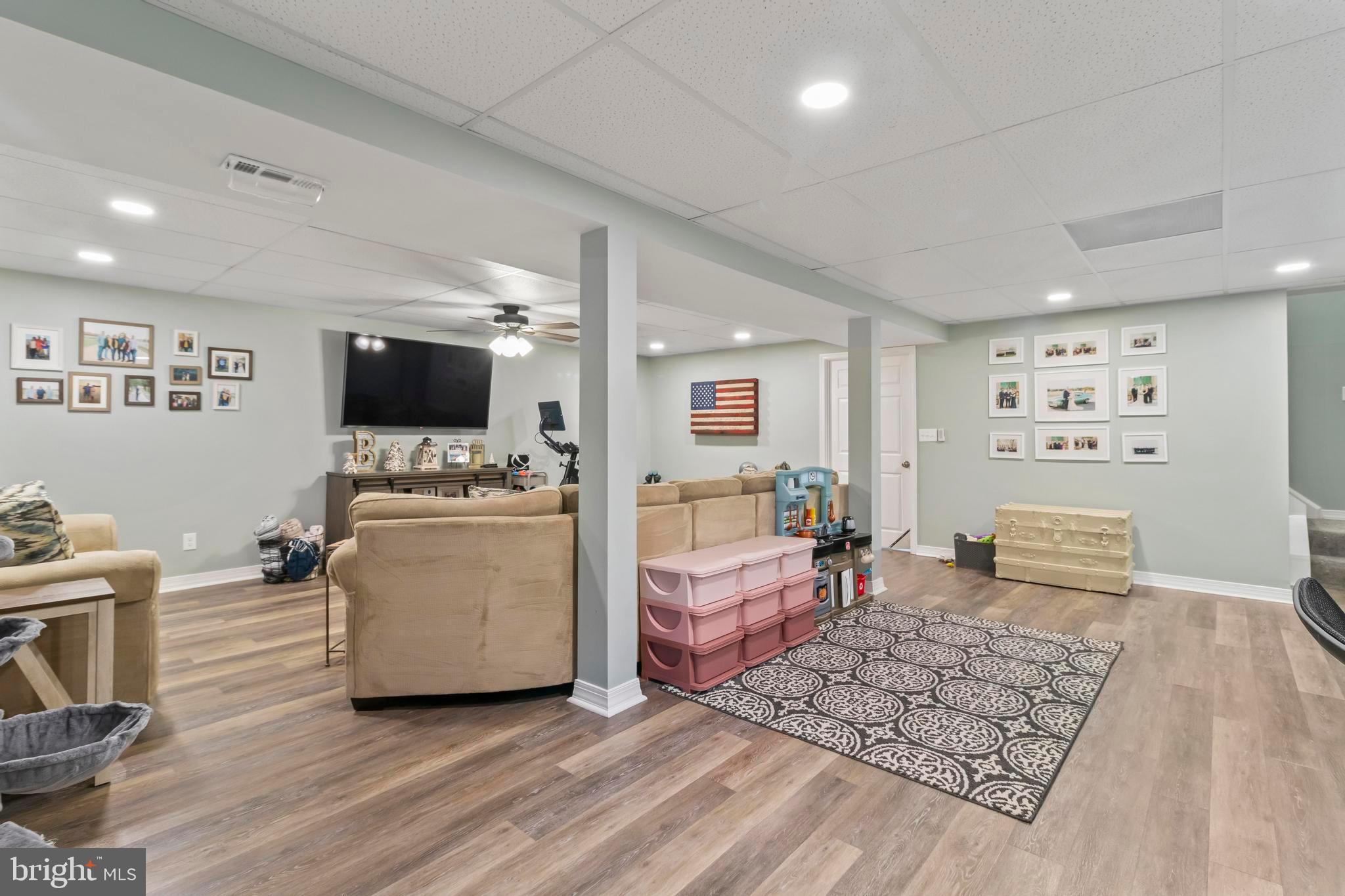 44350 Clarkes Landing Road Hollywood, MD 20636 - Photo 24 of 39 a living room with furniture and a flat screen tv