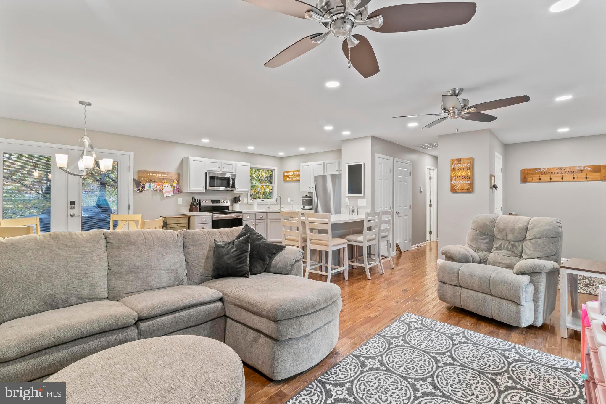 44350 Clarkes Landing Road Hollywood, MD 20636 - Photo 4 of 39 a living room with furniture kitchen view and a chandelier