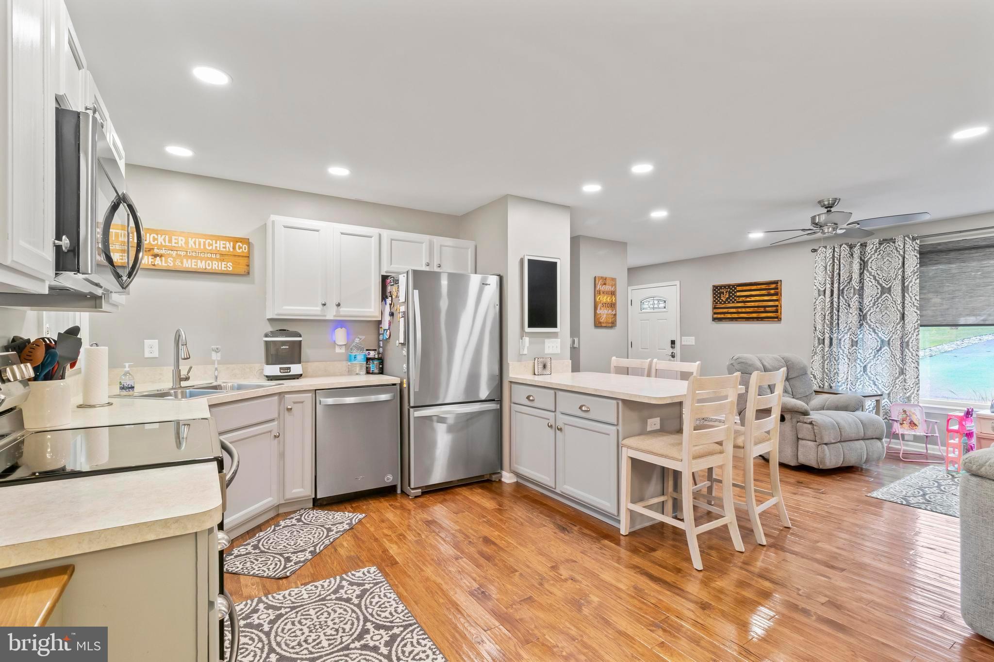 44350 Clarkes Landing Road Hollywood, MD 20636 - Photo 5 of 39 a kitchen with white cabinets and stainless steel appliances