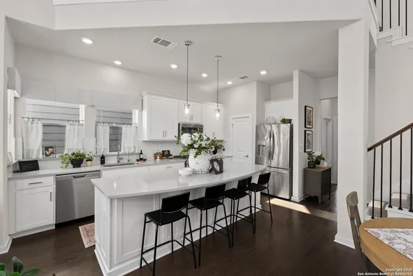 a kitchen with counter space dining table and chairs