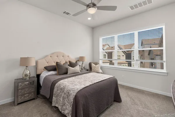 a bedroom with a large bed and a large window