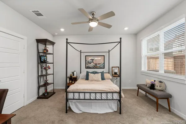 a bedroom with a large bed and a chandelier