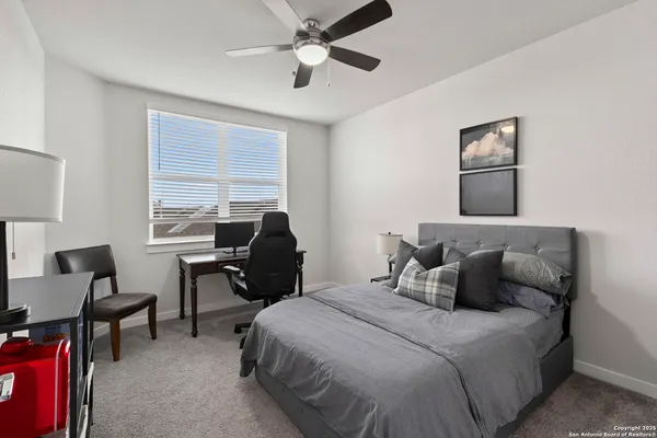 a bedroom with a bed and chair