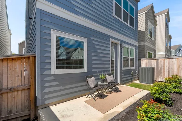 a view of a house with a small backyard