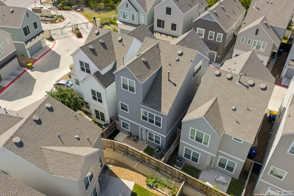 an aerial view of residential houses with outdoor space