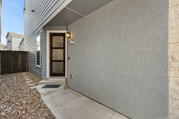 a view of a house with a wooden fence