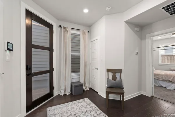 a view of a hallway with wooden floor and closet