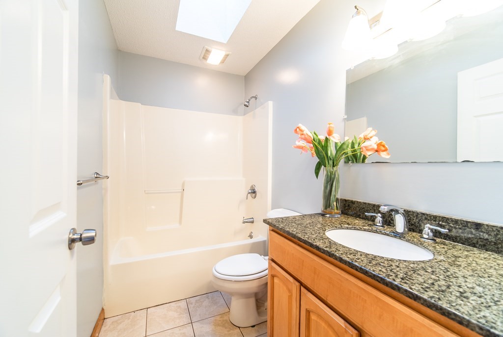 592 Russell Road Westfield, MA 01085 - Photo 13 of 32 a bathroom with a granite countertop sink toilet and shower