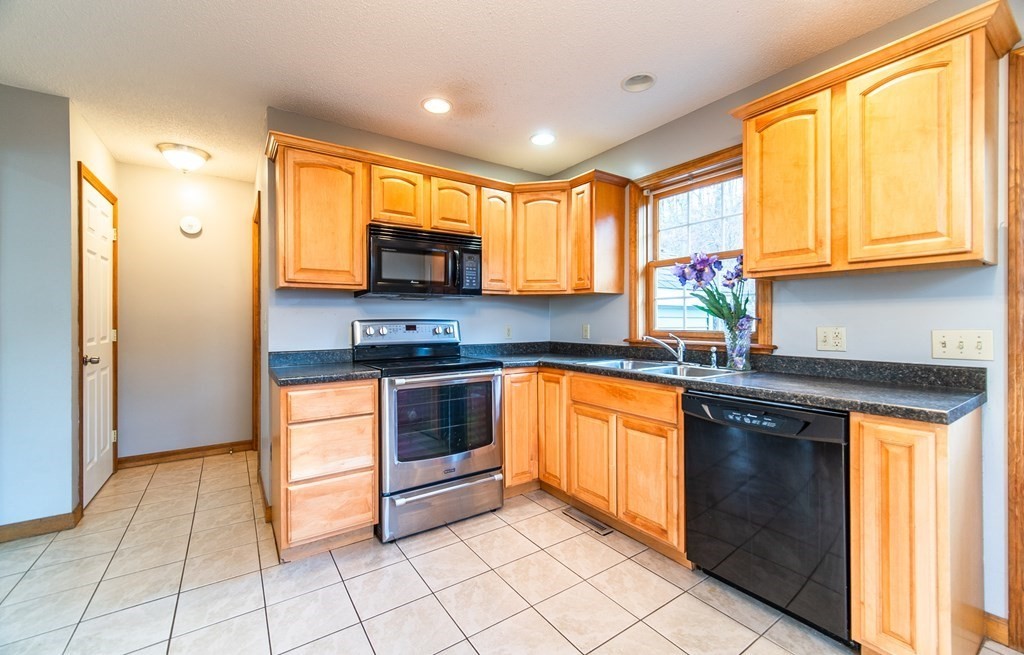 592 Russell Road Westfield, MA 01085 - Photo 5 of 32 a kitchen with stainless steel appliances granite countertop a stove a sink and a microwave