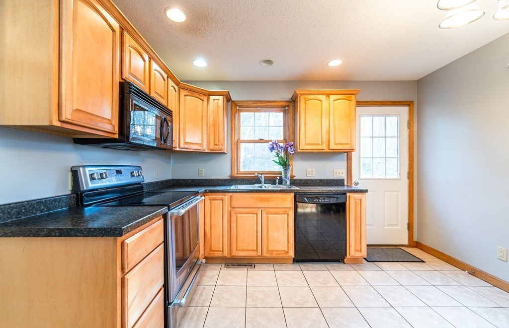 592 Russell Road Westfield, MA 01085 - Photo 6 of 32 a kitchen with stainless steel appliances granite countertop a stove a sink and a microwave