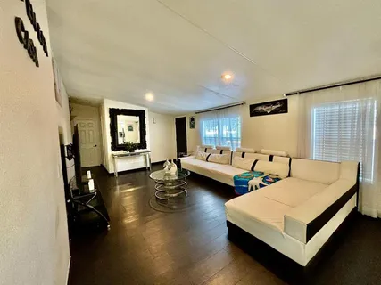 a bedroom with furniture and a wooden floor