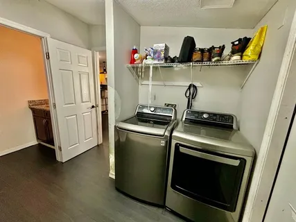 a kitchen with white cabinets and appliances