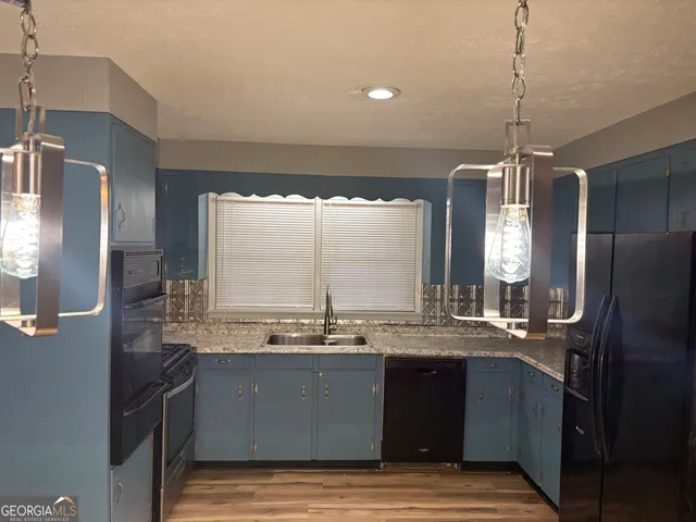 a view of kitchen and dining room with wooden floor