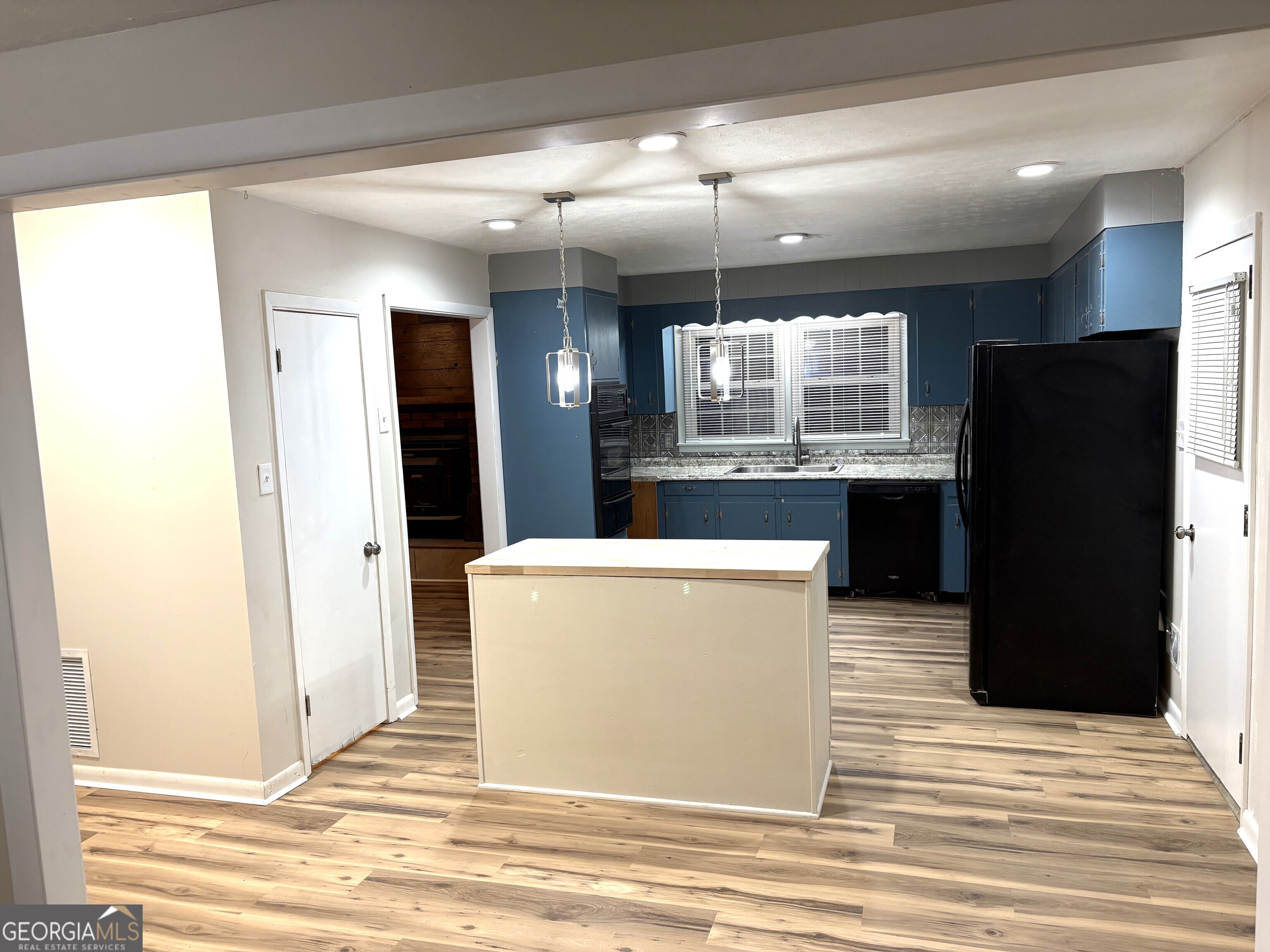 111 Hawthorne Road Warner Robins, GA 31093 - Photo 12 of 22 a view of kitchen and dining room with wooden floor