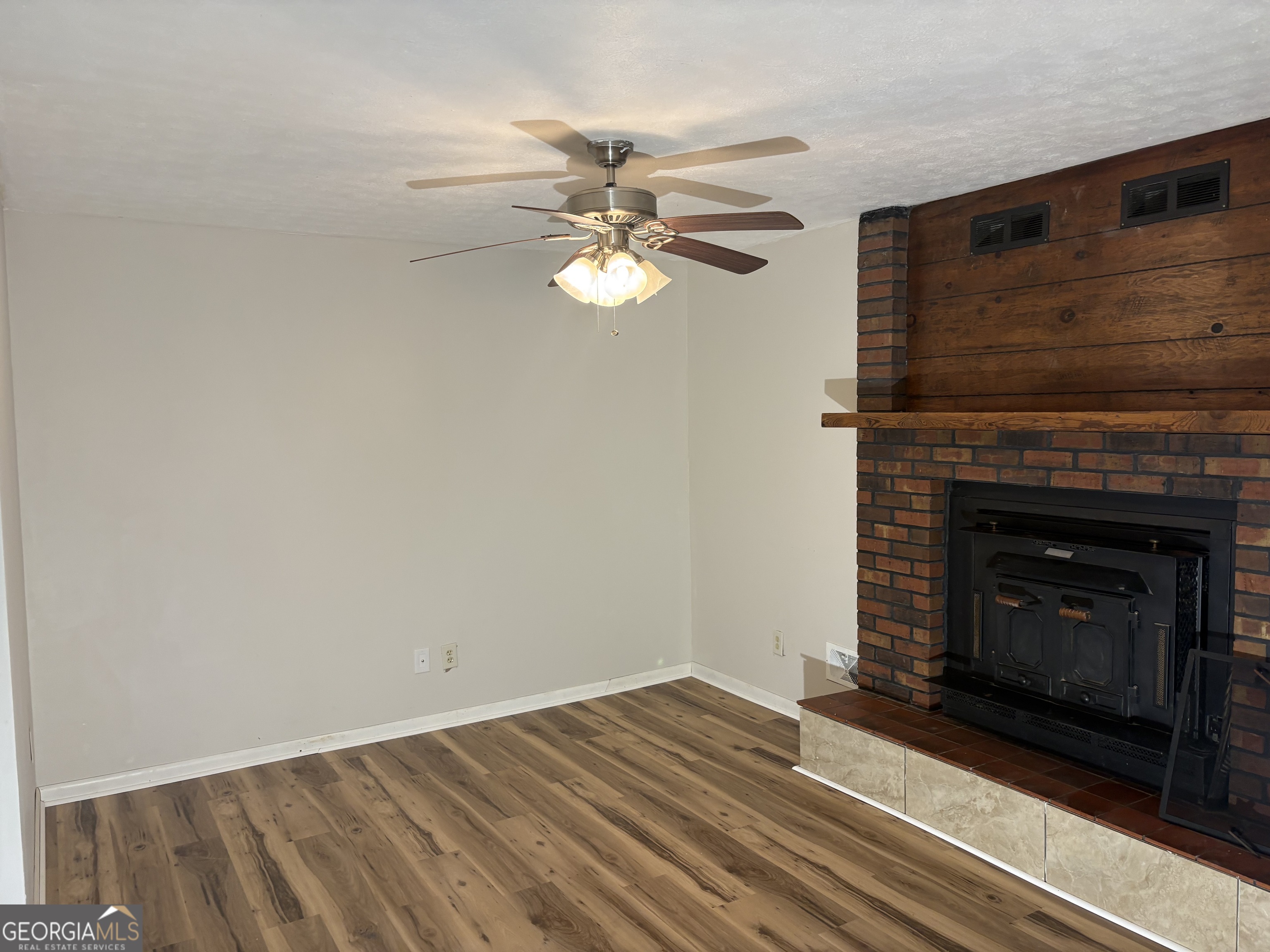 111 Hawthorne Road Warner Robins, GA 31093 - Photo 14 of 22 a view of a livingroom with a fireplace a ceiling fan and wooden floor