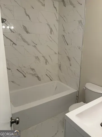 a bathroom with a toilet and a sink