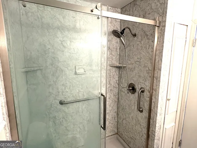 an empty room with a window and wooden floor