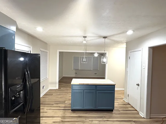 a view of a refrigerator in kitchen and wooden floor