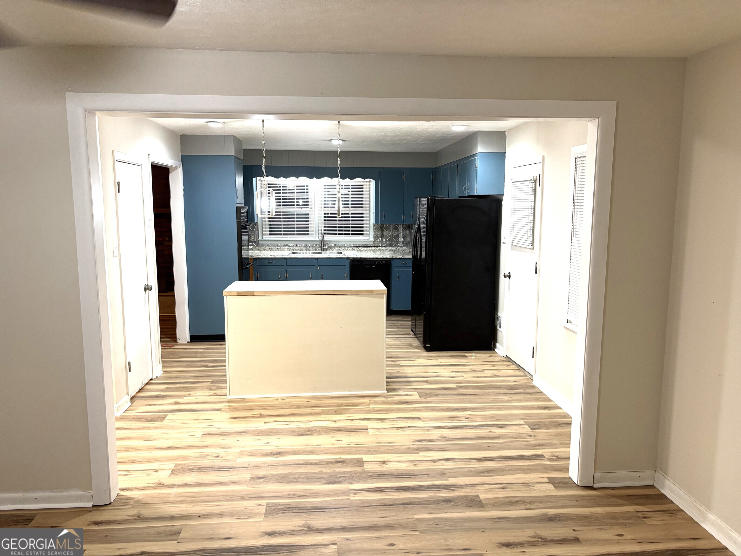 111 Hawthorne Road Warner Robins, GA 31093 - Photo 7 of 22 a view of a refrigerator in kitchen and wooden floor