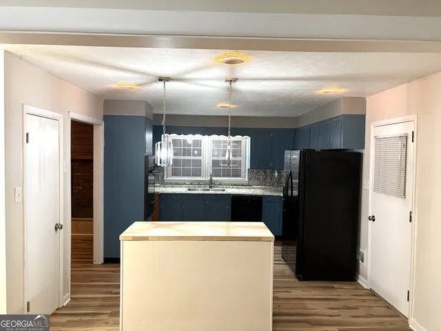a bathroom with a granite countertop sink and shower