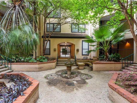 2110 Rio Grande Street, Unit 303 Austin, TX 78705 - Photo 1 of 7 An inviting courtyard entrance welcomes you with lush greenery and a charming stone fountain.