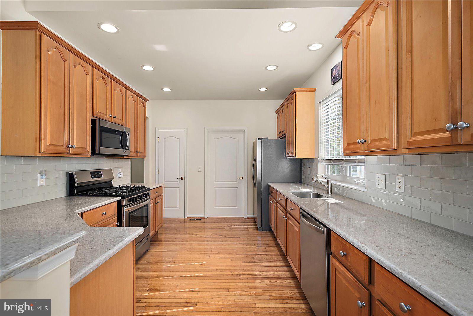 2 Audubon Circle Berlin, MD 21811 - Photo 13 of 71 a kitchen with stainless steel appliances granite countertop a sink stove and refrigerator