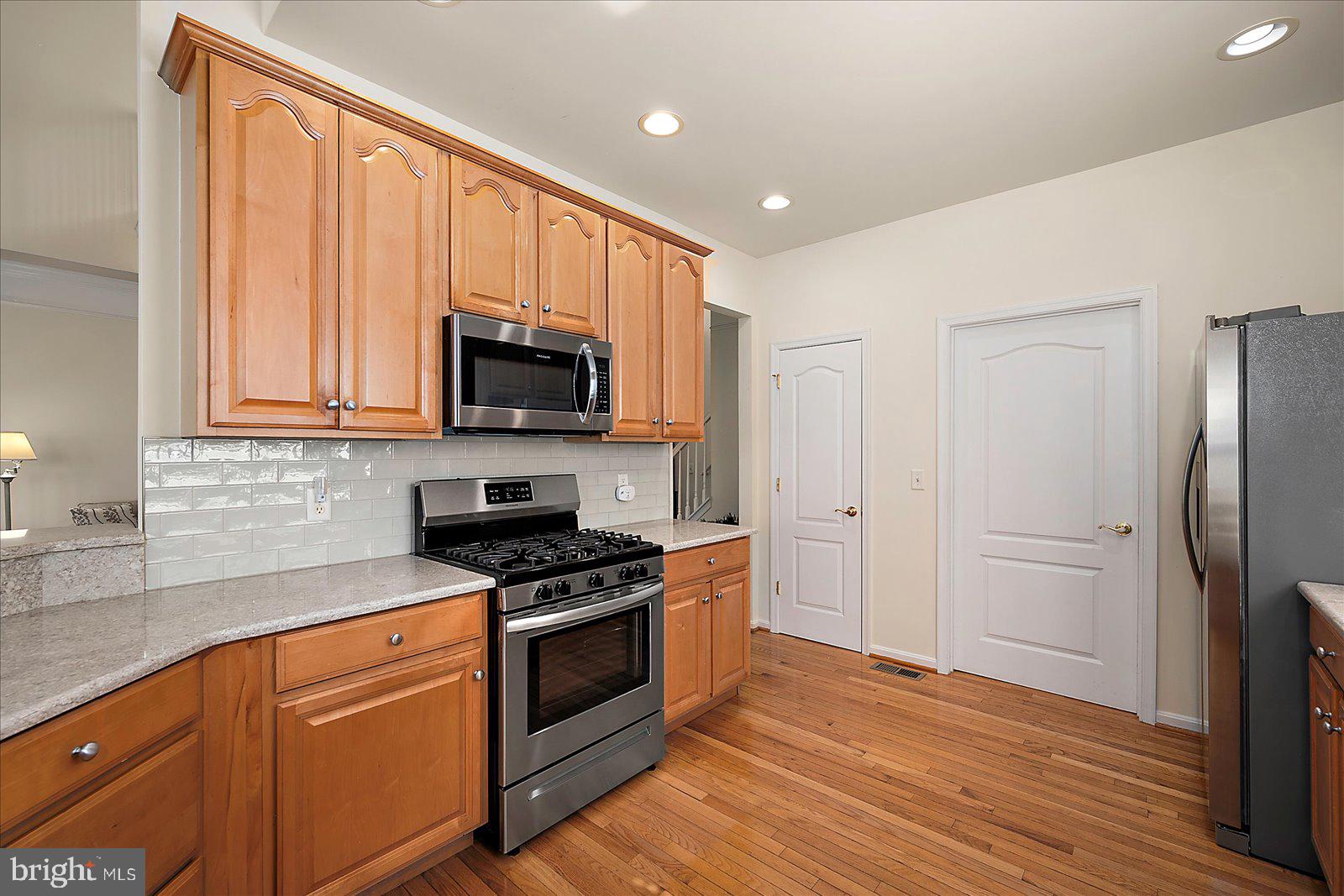 2 Audubon Circle Berlin, MD 21811 - Photo 14 of 71 a kitchen with granite countertop a refrigerator stove and microwave