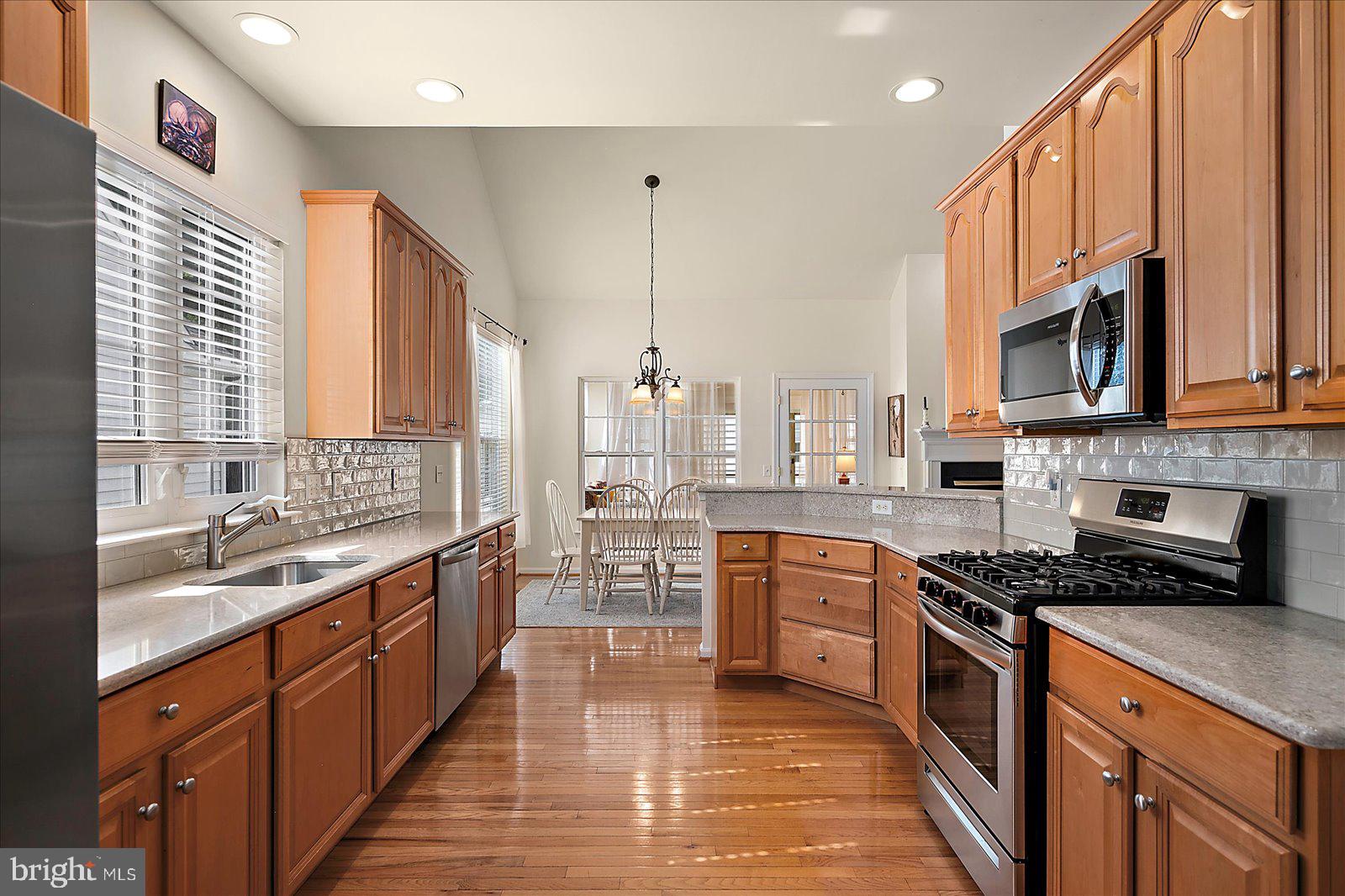 2 Audubon Circle Berlin, MD 21811 - Photo 16 of 71 a kitchen with stainless steel appliances granite countertop a stove a sink and a microwave