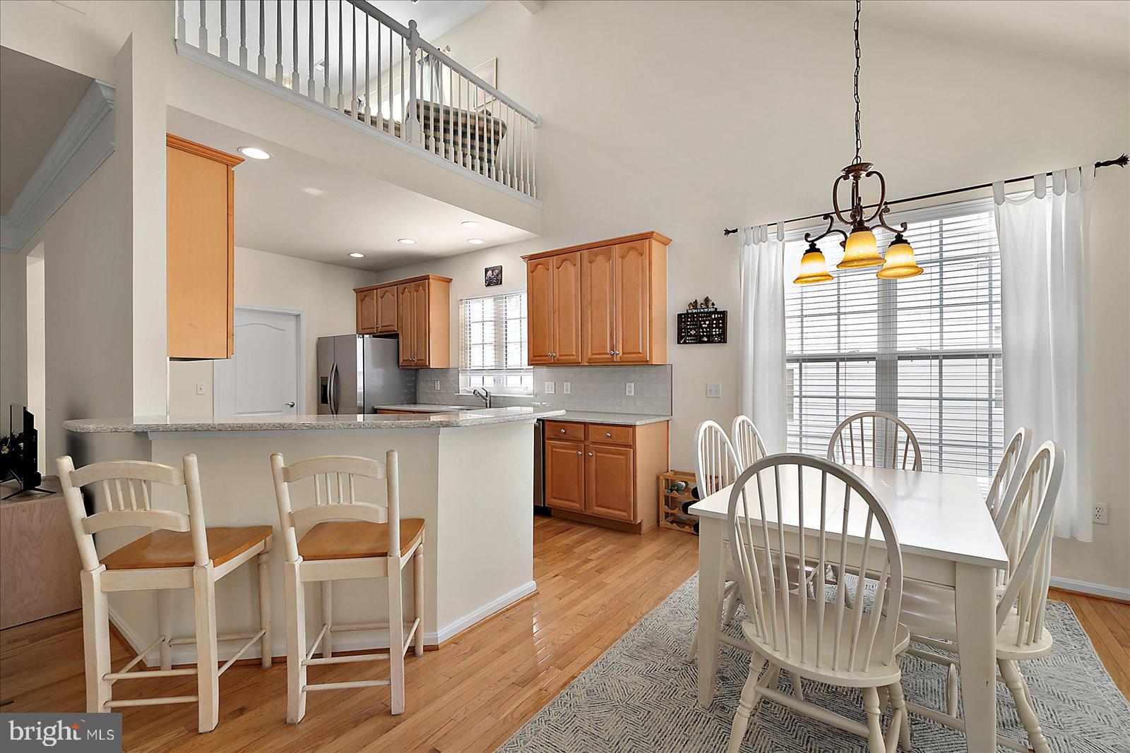 2 Audubon Circle Berlin, MD 21811 - Photo 17 of 71 a kitchen with stainless steel appliances kitchen island granite countertop a dining table chairs and granite counter tops
